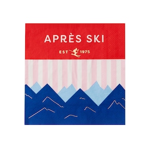 May include: A red and white paper napkin with the words "APRÈS SKI" and "EST 1975" printed on it. The napkin features a skier graphic and a mountain design in blue, light blue, and gold.
