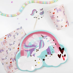 May include: A pastel blue and pink paper plate with a unicorn flying over a rainbow and clouds. The unicorn has a purple mane and tail and gold glitter stars are scattered around the plate.
