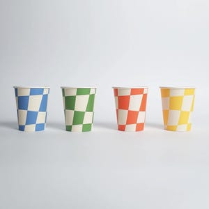 May include: Four paper cups with a checkered pattern in blue, green, orange, and yellow. The cups are arranged in a row on a white background.