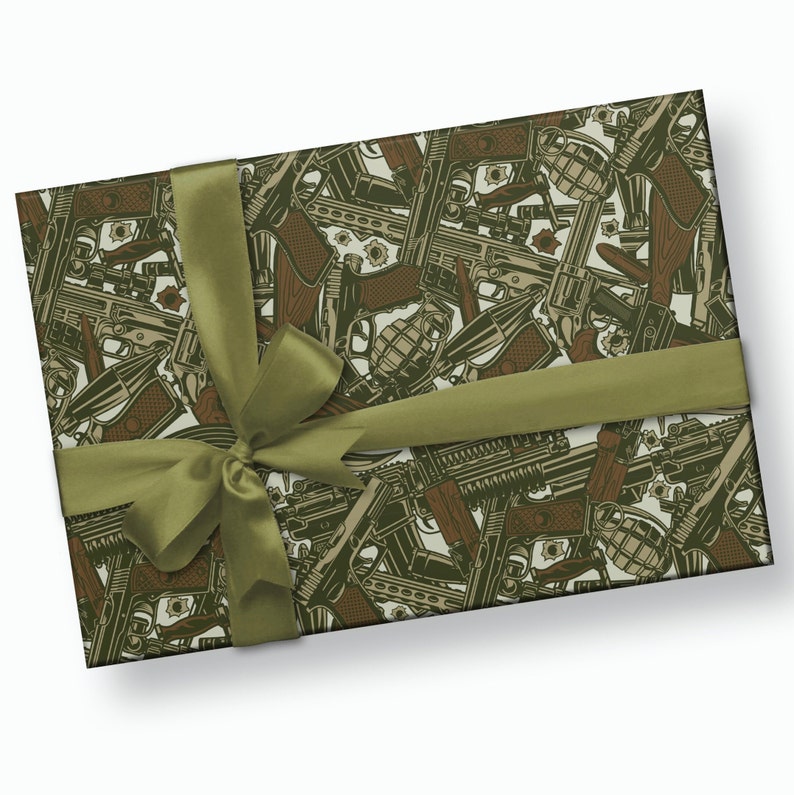 May include: A green and brown gift wrapping paper with a repeating pattern of guns, grenades, and bullets.