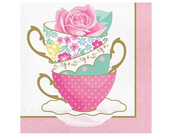 May include: Stack of three pink, green, and white teacups with floral patterns and a single pink rose on top. The teacups are on a white saucer with a gold trim.