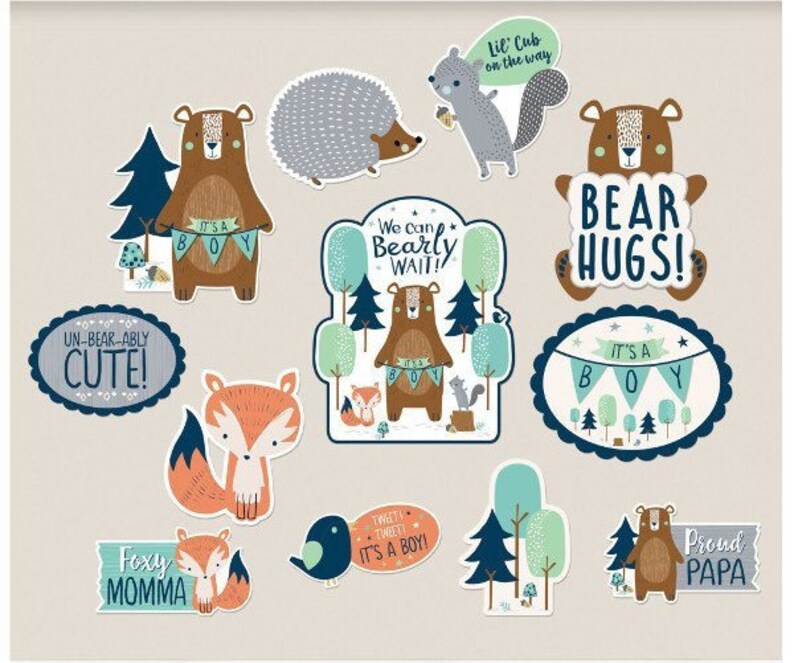 May include: A set of 10 baby shower decorations featuring woodland animals and the text "It's a Boy!" in blue and white. The decorations include a fox, a bear, a hedgehog, and a squirrel. The decorations are perfect for a woodland-themed baby shower.