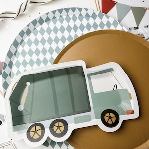 May include: A green and white paper plate with a green garbage truck design. The truck has a white cab and wheels. The plate is on top of a gold paper plate with a diamond pattern.