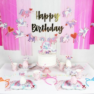 May include: A unicorn-themed birthday party table setting with pink and white paper goods, a unicorn cake with a rainbow topper, and a unicorn headband. The cake says "Chloe is Six".
