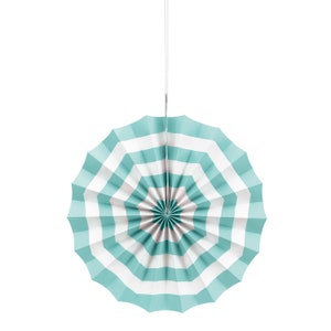 May include: A teal and white striped paper fan hanging from a white string. The fan is folded in a circle shape.