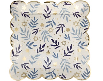 May include: Square paper plate with a scalloped gold edge. The plate features a cream background with a pattern of blue and navy leaves, gold stars, and gold dots. A decorative item for a party or event.