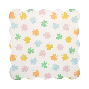 May include: A white, scalloped-edge paper plate decorated with a repeating pattern of pastel-colored shamrocks. The shamrocks are in shades of orange, yellow, pink, green, and blue. The plate is perfect for a St. Patrick's Day celebration or a spring-themed event.