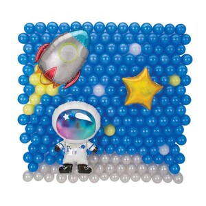 May include: A blue and white balloon backdrop with a silver rocket, a white astronaut, and a gold star. The balloons are arranged in a grid pattern.