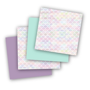 May include: Four sheets of paper with a mermaid scale pattern. The sheets are in shades of purple, light blue, and white.