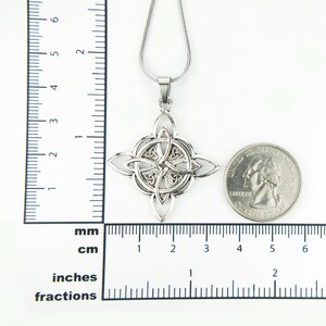 May include: Silver Celtic knot pendant necklace with a chain. The pendant is about 1 inch in diameter and is shown next to a US quarter for size comparison.