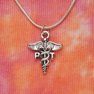 May include: Silver necklace with a medical caduceus charm and the letters "PT" on it.