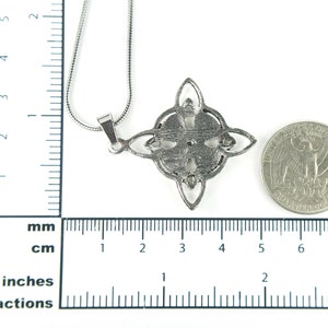 May include: Silver pendant necklace with a Celtic knot design. The pendant is about the size of a quarter.