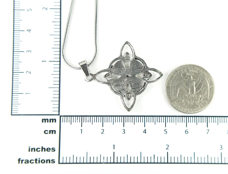 May include: Silver pendant necklace with a Celtic knot design. The pendant is about the size of a quarter.