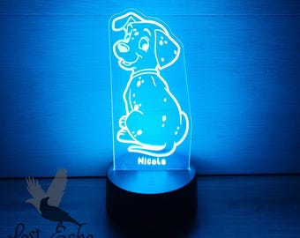 May include: A white Dalmatian puppy night light with a blue glow. The light has a black base and the name "Nicole" is printed on the front.