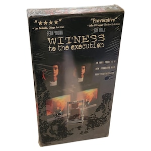May include: Sealed VHS tape for the movie "Witness to the Execution" featuring Sean Young and Tim Daly. The cover is black with images of the actors and the title in white. Includes quotes from critics.