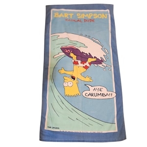 May include: A blue beach towel featuring Bart Simpson surfing a wave. The towel has the text "BART SIMPSON RADICAL DUDE" at the top and "AYE CARUMBA!!" in a speech bubble. The image is a cartoon style.