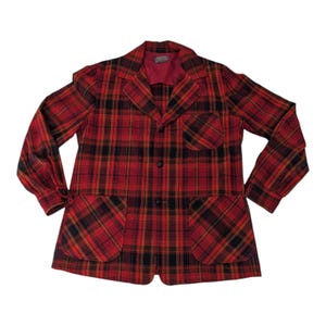 May include: A red, black, and yellow plaid jacket with two large front pockets and a notched collar. The jacket has long sleeves and a button-up front. The interior lining is red. The jacket is a vintage style.