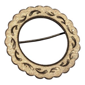 May include: A circular brooch with a scalloped edge and a textured, gold-toned surface. The brooch features a dark, curved design around the inner circle. A pin is attached to the back. This vintage-style accessory is suitable for various outfits.
