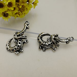 May include: Two silver alligator charms with a detailed design. The charms are perfect for jewellery making or crafting projects.