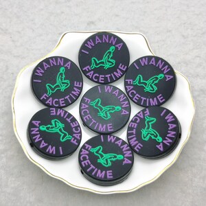 May include: Eight black and green phone grips with the text "I Wanna Facetime" in purple.