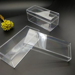 May include: Three clear plastic boxes of various sizes. The boxes are empty and have a rectangular shape.