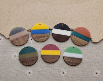 May include: Seven round wooden pendants with different colored resin inlays. The pendants are all the same size and have a hole at the top for hanging.