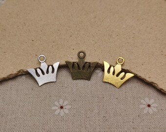 May include: Three crown charms in different finishes: silver, bronze, and gold. The charms are in the shape of a crown with a loop at the top for attaching to jewelry or other crafts.