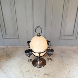 Antique set of 4 silver plated egg cups with egg on stand