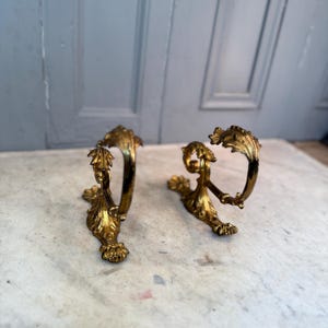 Pair of antique French bronze ormolu curtain tiebacks brackets