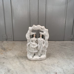 Antique Staffordshire figure ornament of courting couple