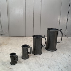 Set of 4 antique pewter measures