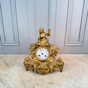 Antique French decorative gilt spelter mantel clock with girl holding bird