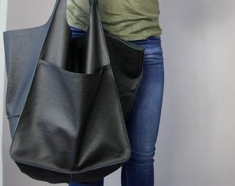 Oversized zwarte leren draagtas: grote slouchy koeienhuid schoudertas met zakken