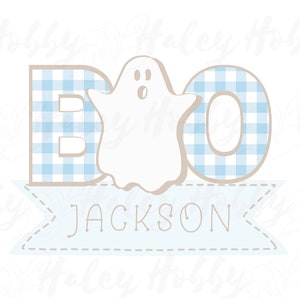 May include: A blue and white gingham BOO banner with a white ghost in the middle. The banner has a blue ribbon with the name JACKSON written on it.