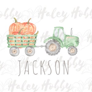 May include: A green toy tractor pulling a wagon filled with orange pumpkins. The wagon has a green wooden frame and the tractor has black wheels. The text "JACKSON" is written below the tractor.