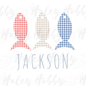 May include: Three fish-shaped ornaments with gingham patterns in red and white, tan and white, and blue and white. The name "JACKSON" is written below the ornaments.