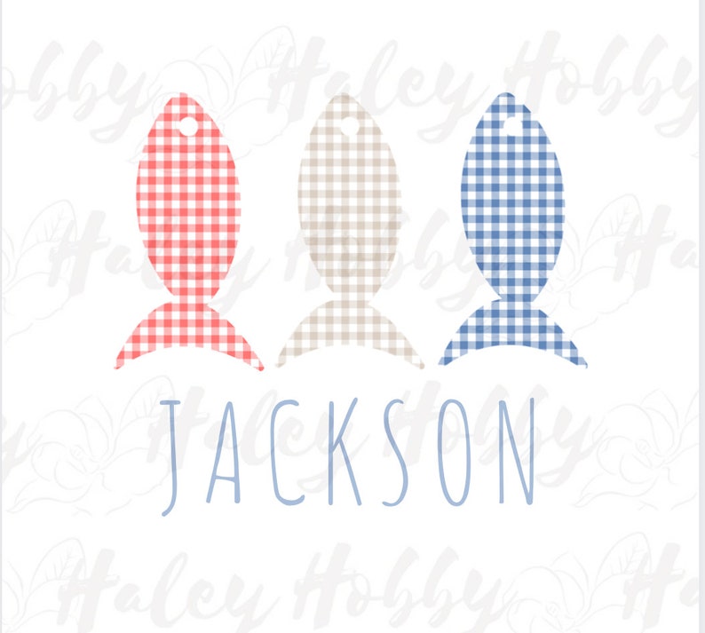 May include: Three fish-shaped ornaments with gingham patterns in red and white, tan and white, and blue and white. The name "JACKSON" is written below the ornaments.