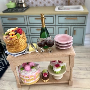 1/12 dollhouse miniature - a small table with pancakes, cakes and cupcakes, champagne and wine