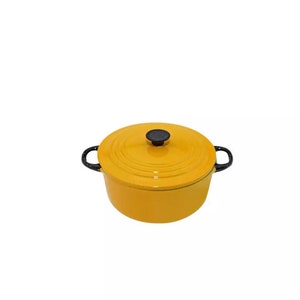 May include: Yellow enamel cast iron pot with black handles and lid. The pot has a round shape and a smooth surface.