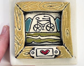 clique tile - bike frame on matte white glaze