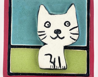 clique tile - cat in red frame
