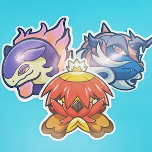 May include: Three cartoon character stickers featuring a purple and pink creature with flames, a blue and white creature with horns, and a red and orange flower-like creature.