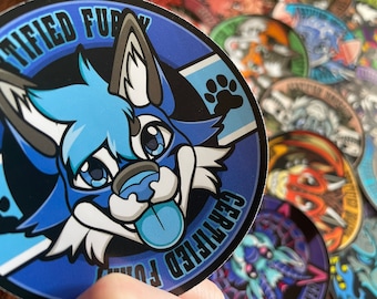May include: A blue and white sticker with a cartoon furry animal with a blue tongue. The sticker says "Certified Furry" in a black circle.