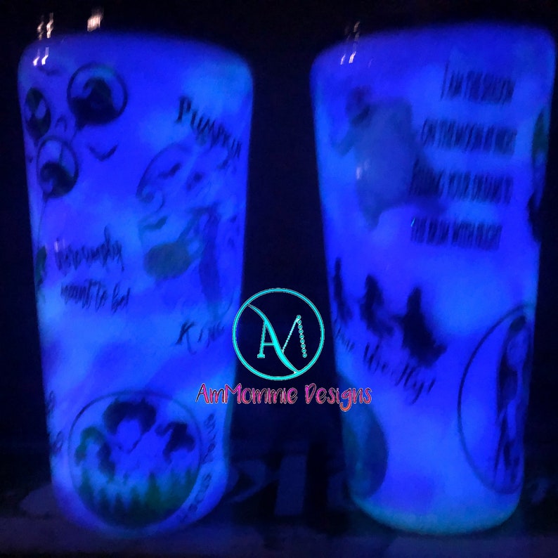 May include: Two glow-in-the-dark tumblers with a Nightmare Before Christmas theme. The tumblers feature Jack Skellington, Sally, and other characters from the movie. One tumbler has the text "This is Halloween" and the other has the text "Pumpkin King".