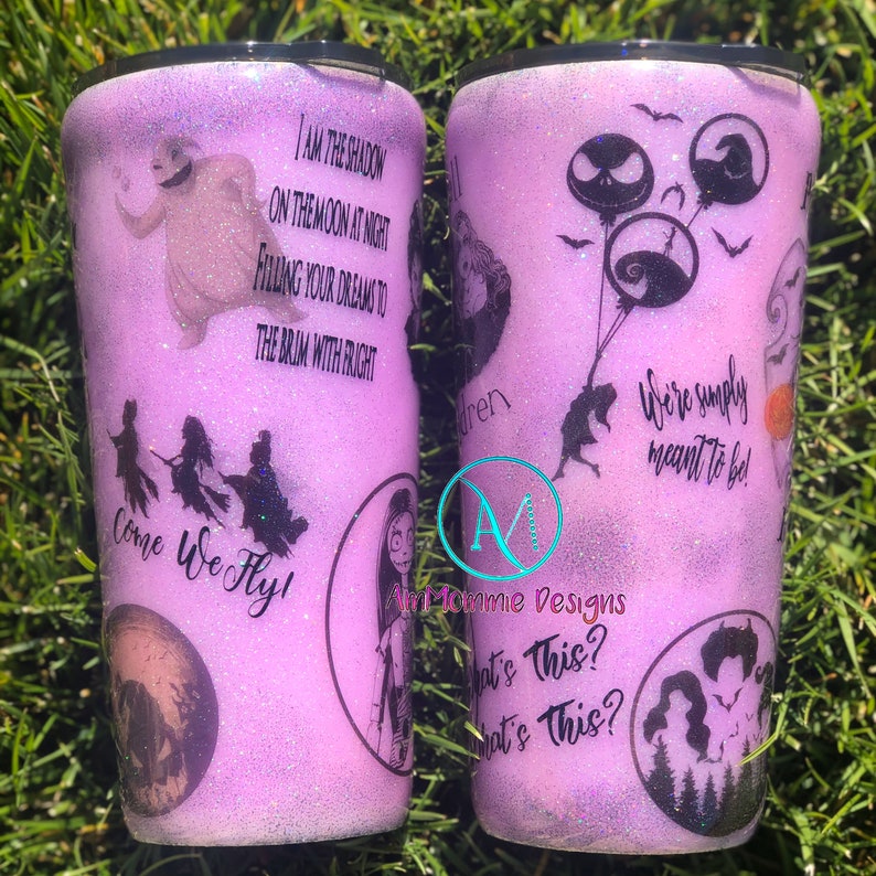 May include: A purple glitter tumbler with a Nightmare Before Christmas theme. It features characters like Jack Skellington, Sally, and the three witches. The tumbler has quotes from the movie, including "I am the shadow on the moon at night, filling your dreams to the brim with fright" and "We're simply meant to be!"
