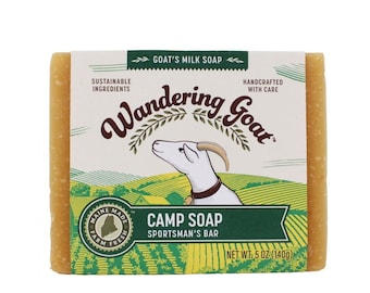 May include: A bar of yellow goat's milk soap with a green label that says "Wandering Goat" and "Camp Soap Sportsman's Bar". The label also features a cartoon goat and a green and yellow field. The soap weighs 140 grams (5 ounces).