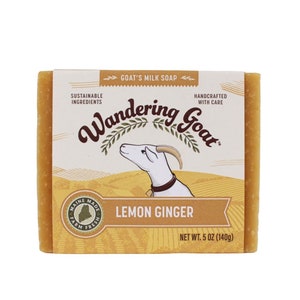 May include: A bar of yellow goat milk soap with the text "Wandering Goat" and "Lemon Ginger" on the label. The label also says "Sustainable Ingredients" and "Handcrafted with Care". The soap weighs 5 ounces (140 grams).