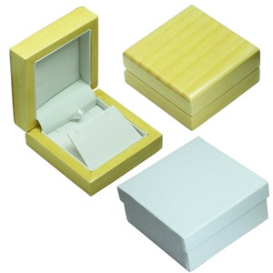 May include: Three different jewelry boxes. Two are made of light wood with a white interior. The third is white cardboard. All are closed.