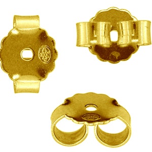 May include: Gold-tone earring backs with a scalloped edge and a small hole in the center. The backs have a double-prong design for a secure fit.