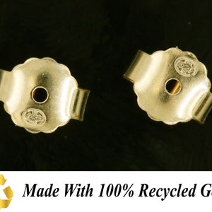 May include: Two gold-toned earring backs with a small hole in the center. The backs are made with 100% recycled gold.